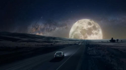 Cadillac driving towards huge moon